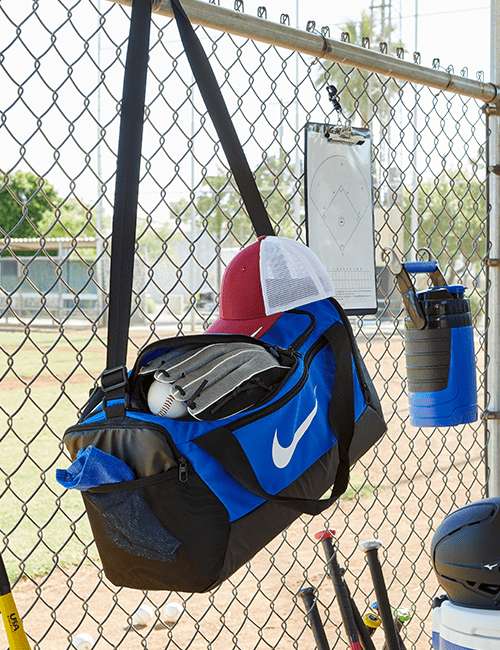 nike bag hanging from fence